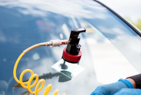 Resin injector tool repairing a chip in a windshield